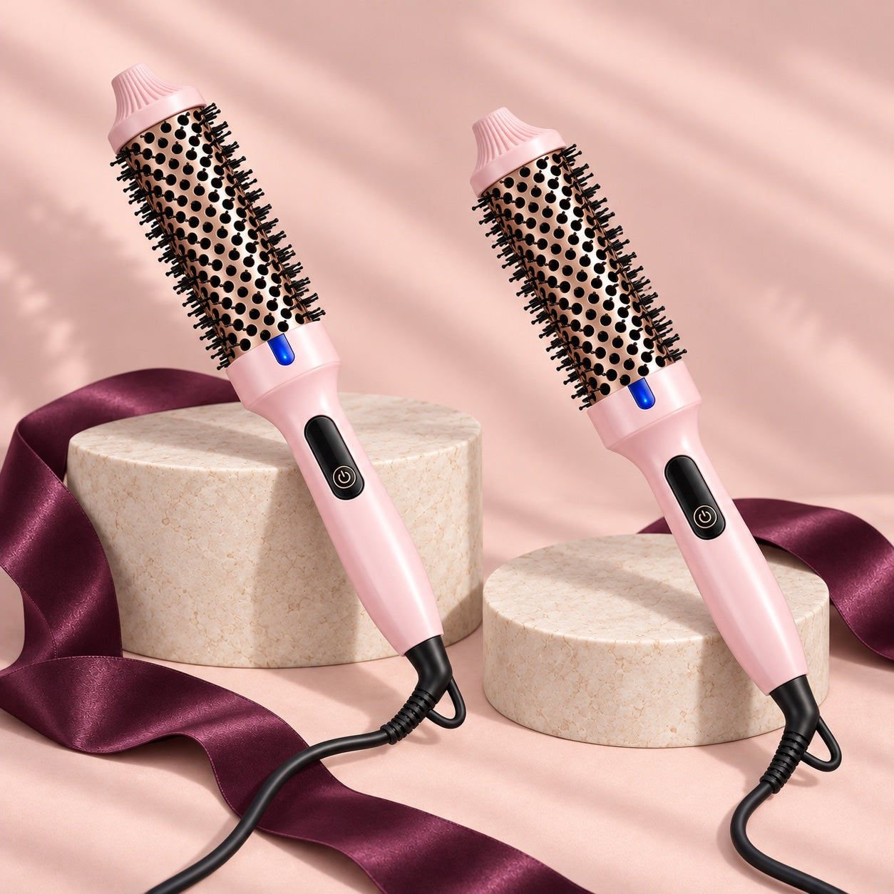 Two blush pink Wavyy thermal styling brushes