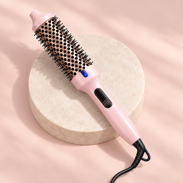 Blush pink Wavyy 38mm thermal styling brush on an ivory pedestal.